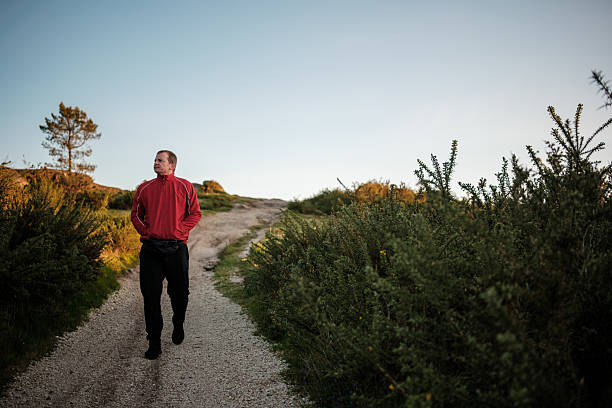 Solitary walker on a quiet bush trail in mindful contemplation